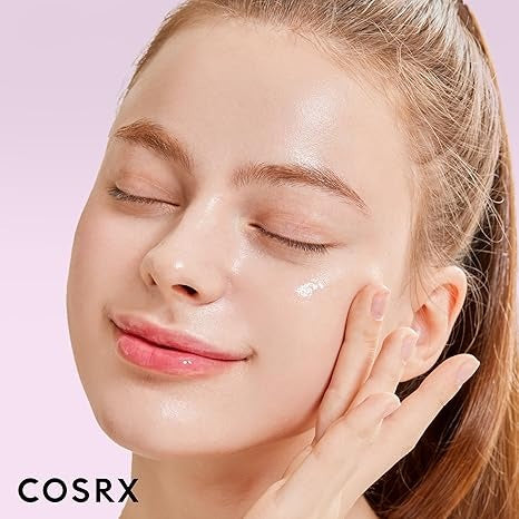 Woman applying skincare product with a pink background and COSRX branding